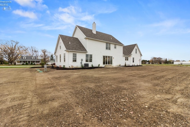 rear view of house featuring central AC