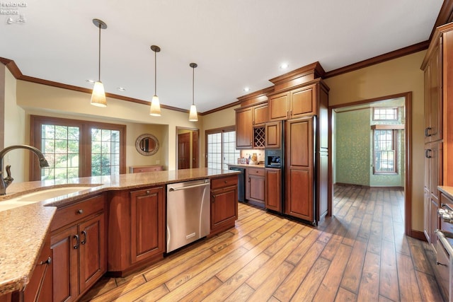 kitchen featuring light stone countertops, sink, dishwasher, light hardwood / wood-style flooring, and pendant lighting