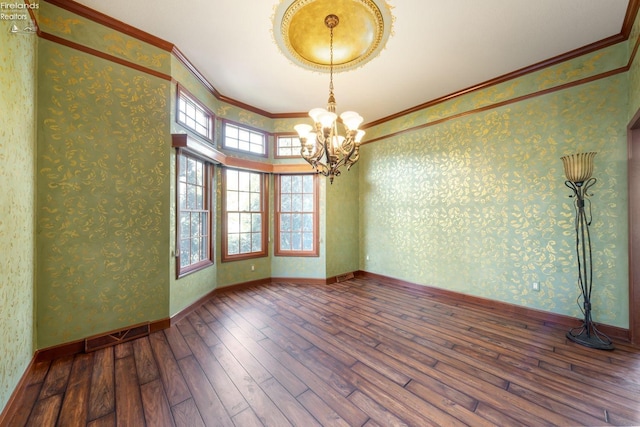 spare room with hardwood / wood-style flooring, crown molding, a high ceiling, and an inviting chandelier