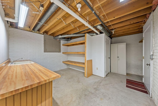 basement with sink and brick wall