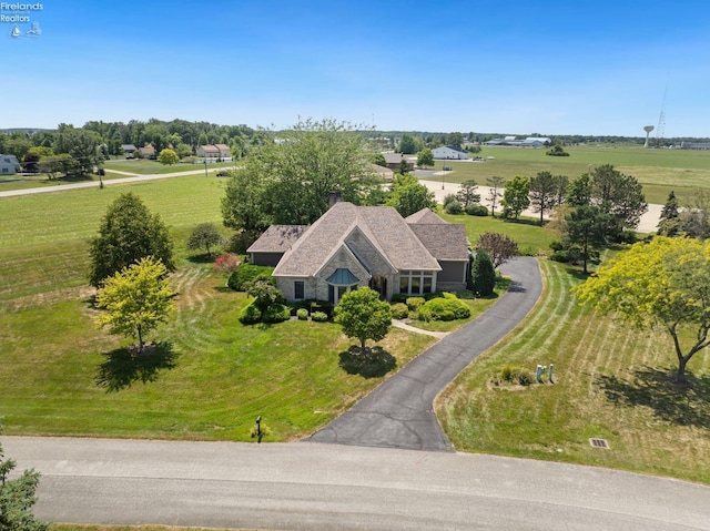 birds eye view of property with a rural view