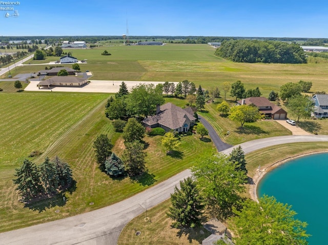 birds eye view of property with a rural view and a water view