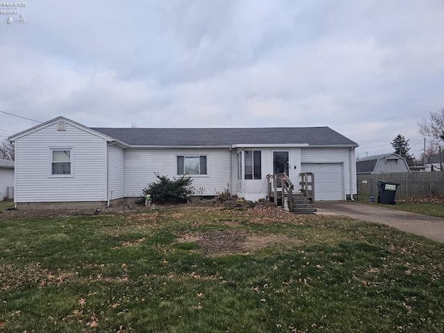 single story home featuring a front lawn and a garage