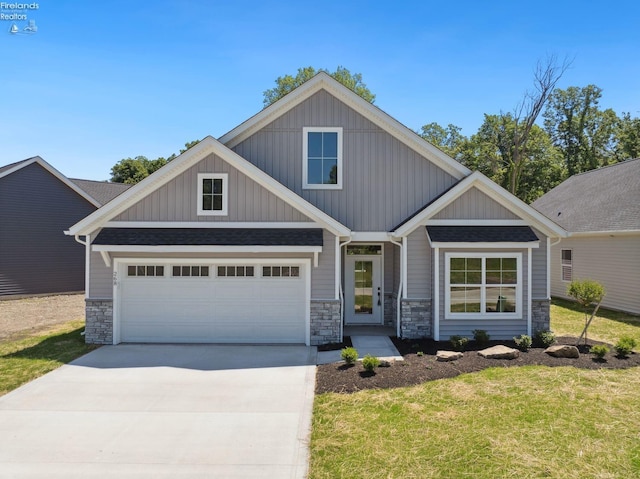 craftsman inspired home featuring a garage, stone siding, driveway, and a shingled roof