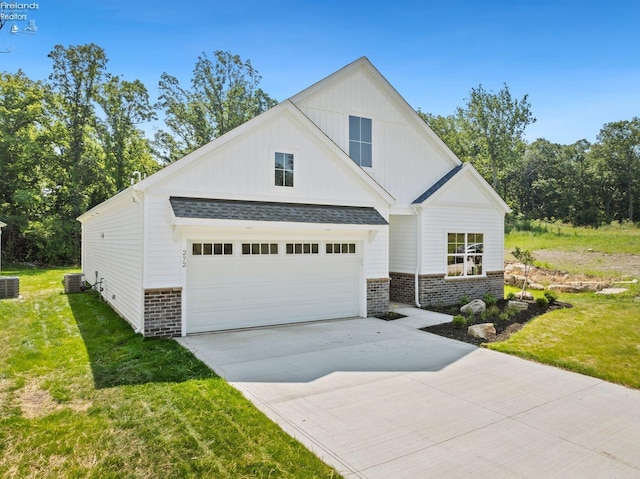 view of front facade featuring driveway, brick siding, a front lawn, and cooling unit