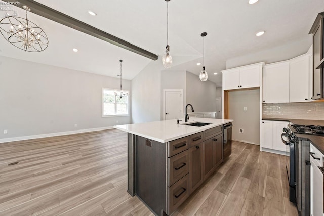 kitchen with dishwashing machine, vaulted ceiling with beams, an inviting chandelier, black range with gas stovetop, and a sink