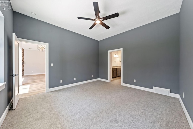 unfurnished bedroom with visible vents, baseboards, connected bathroom, a ceiling fan, and carpet floors