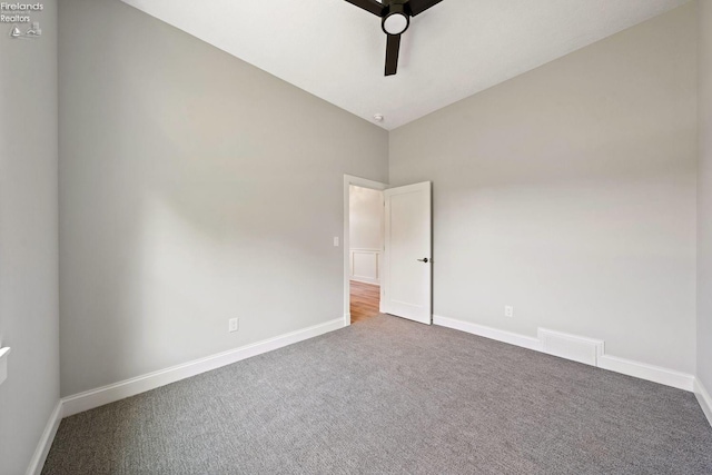 unfurnished bedroom featuring vaulted ceiling, ceiling fan, carpet flooring, and baseboards