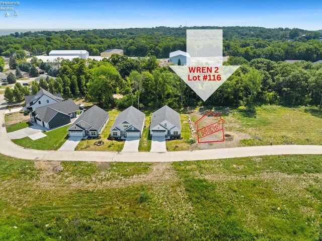 birds eye view of property with a residential view and a wooded view