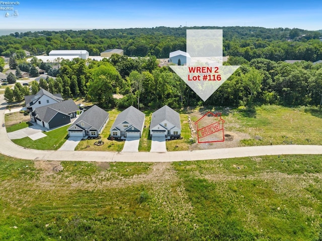 drone / aerial view with a residential view and a forest view