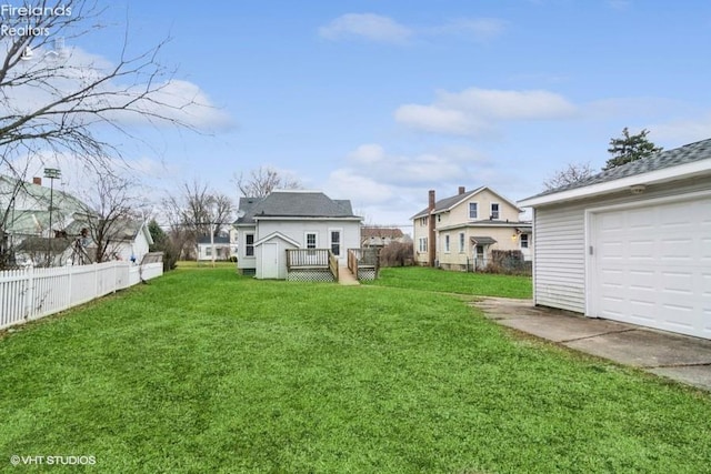 view of yard with a wooden deck and an outbuilding