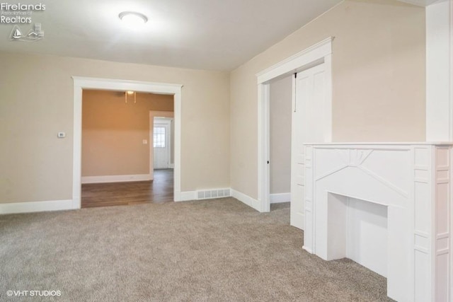 unfurnished living room with light carpet