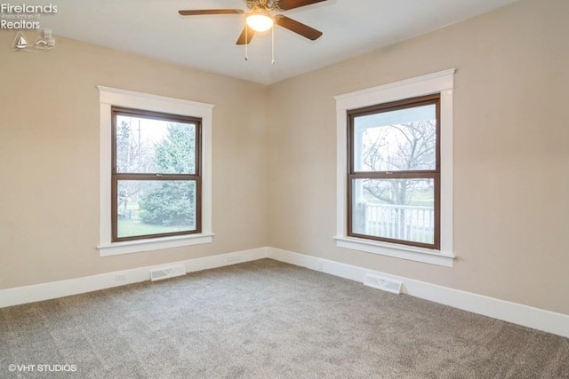 carpeted spare room with ceiling fan