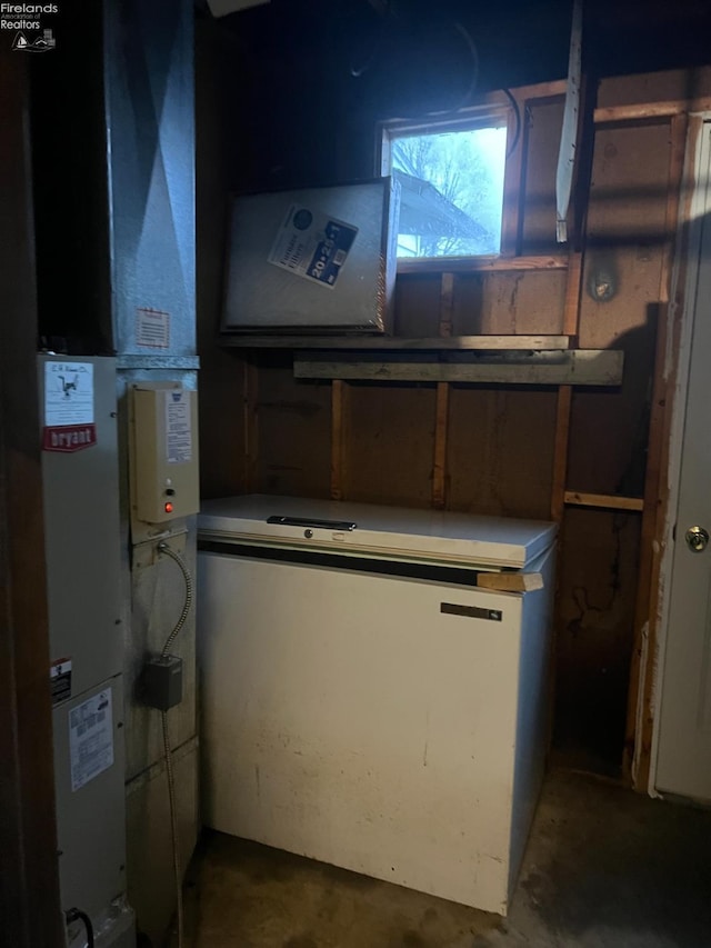 utility room featuring heating unit