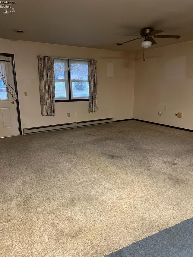 carpeted empty room featuring ceiling fan and a baseboard radiator