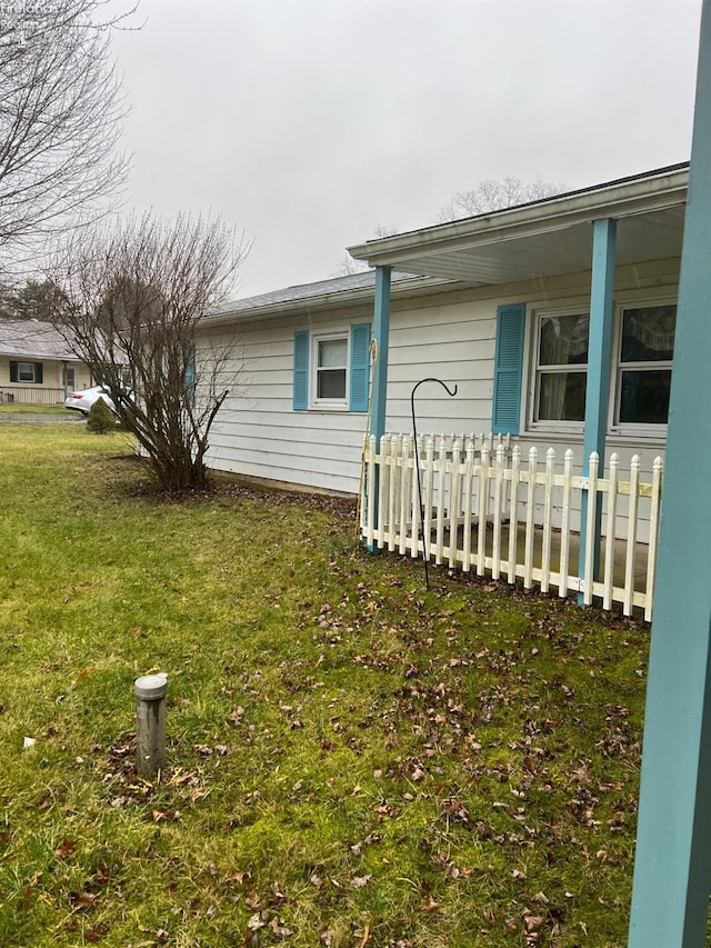 view of side of home featuring a lawn