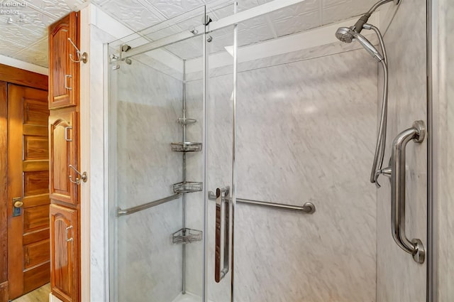 bathroom featuring a shower with door