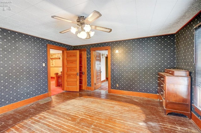 spare room featuring hardwood / wood-style flooring, ceiling fan, and ornamental molding