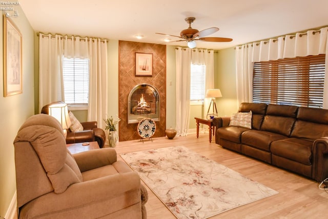 living room with ceiling fan and light wood-type flooring