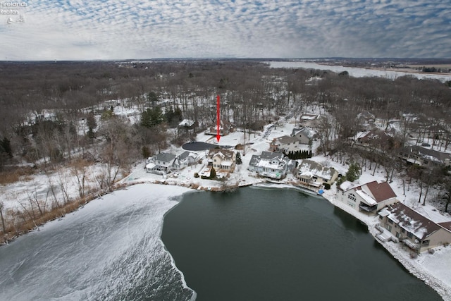 snowy aerial view featuring a water view