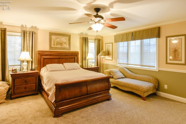 carpeted bedroom with multiple windows, ceiling fan, and crown molding