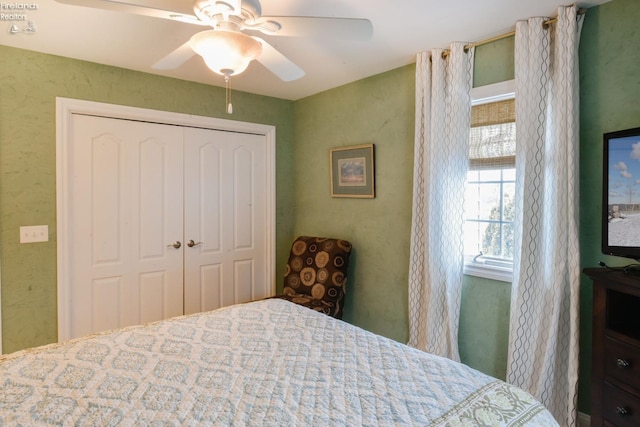 bedroom with ceiling fan and a closet