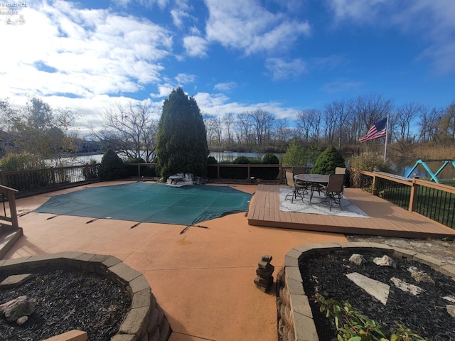 view of pool with a deck with water view