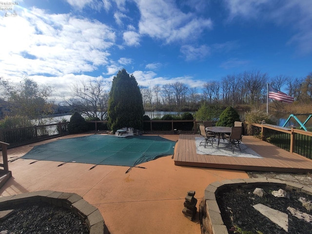 view of swimming pool with a deck with water view and a patio