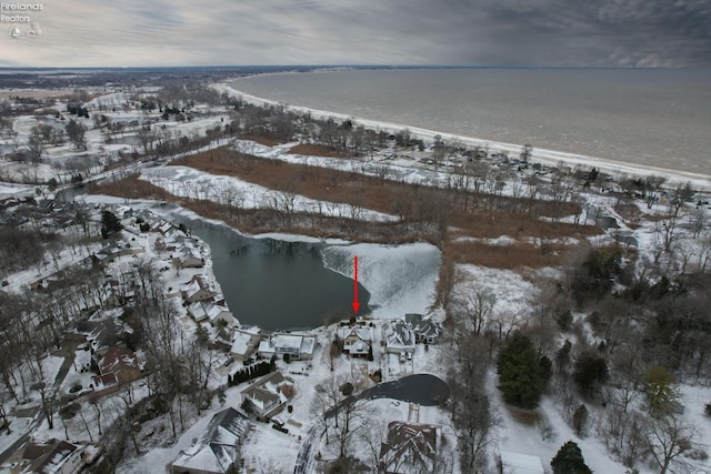 snowy aerial view with a water view