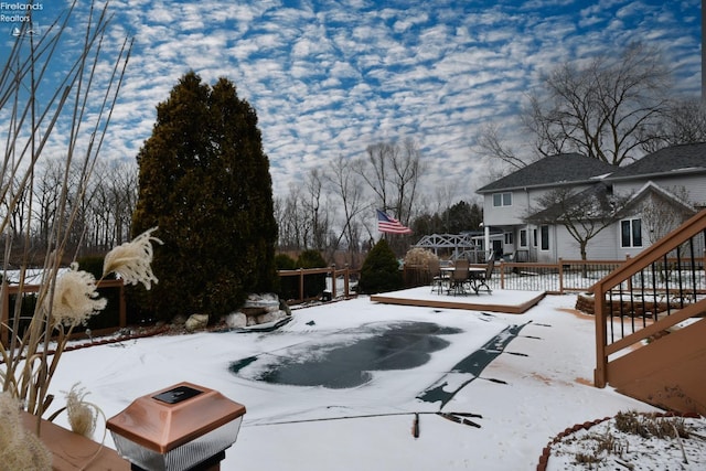 yard covered in snow featuring a deck