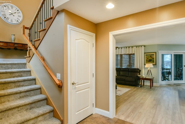 stairs featuring hardwood / wood-style flooring