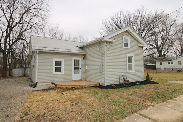 view of front facade with a wooden deck and a front yard