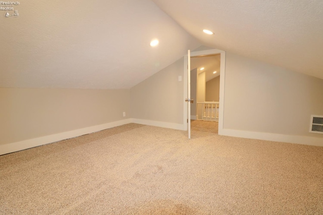 bonus room featuring carpet floors and lofted ceiling