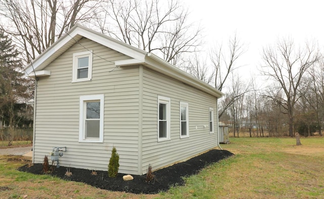 view of side of home with a yard