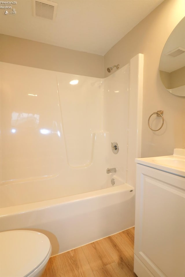 full bathroom featuring vanity, shower / bathing tub combination, wood-type flooring, and toilet