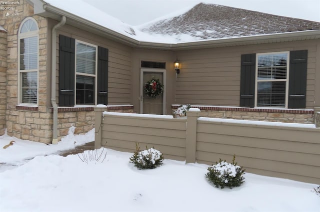 view of snow covered property entrance