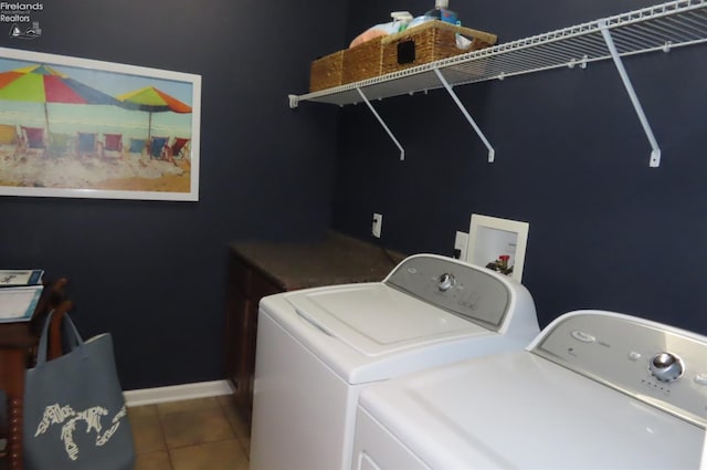 laundry room with tile patterned flooring and washer and dryer