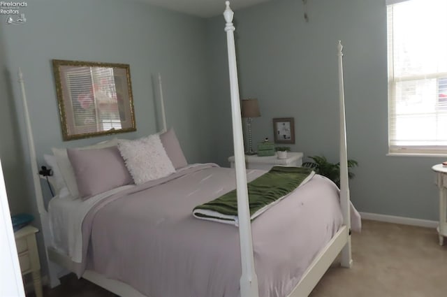 bedroom featuring light carpet