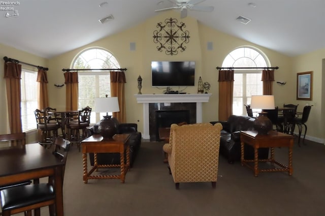 living room featuring carpet flooring, ceiling fan, a fireplace, and vaulted ceiling