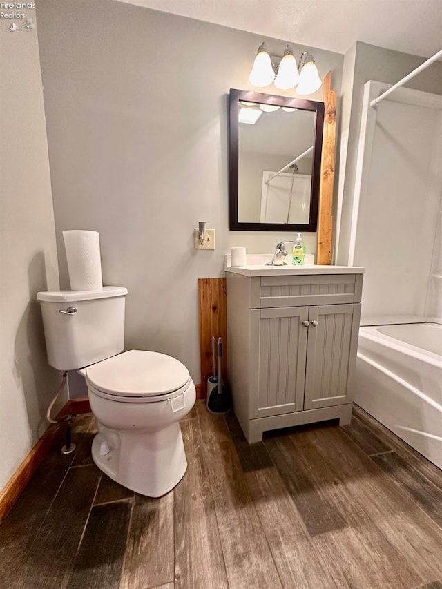 full bathroom featuring shower / bath combination, wood-type flooring, toilet, and vanity