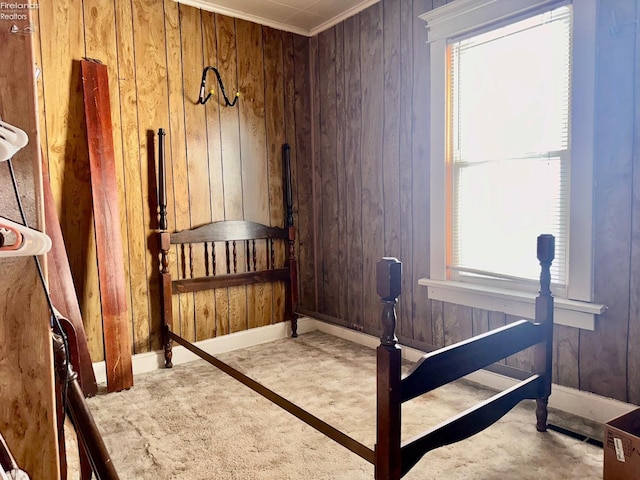 bedroom featuring wood walls and multiple windows