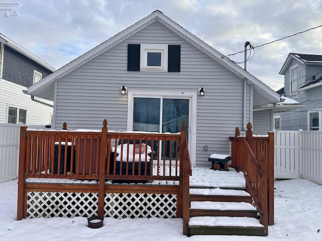 snow covered property with a wooden deck