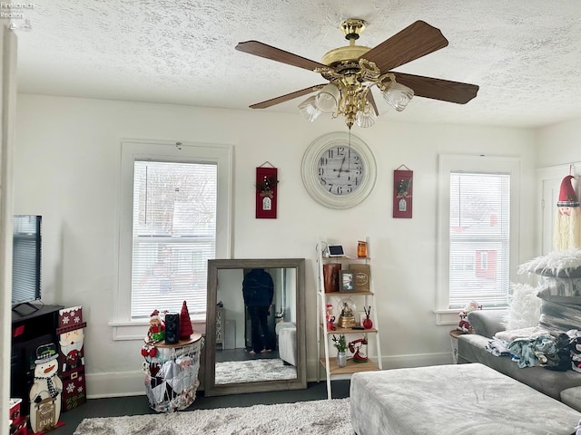 bedroom with ceiling fan and a textured ceiling