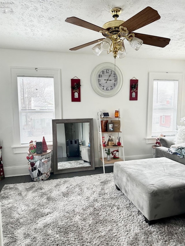 bedroom with a textured ceiling and ceiling fan