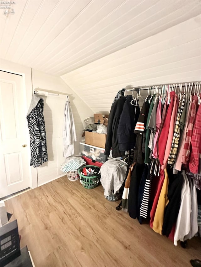 walk in closet featuring lofted ceiling and wood-type flooring