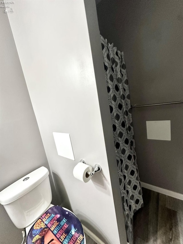 bathroom featuring hardwood / wood-style floors and walk in shower