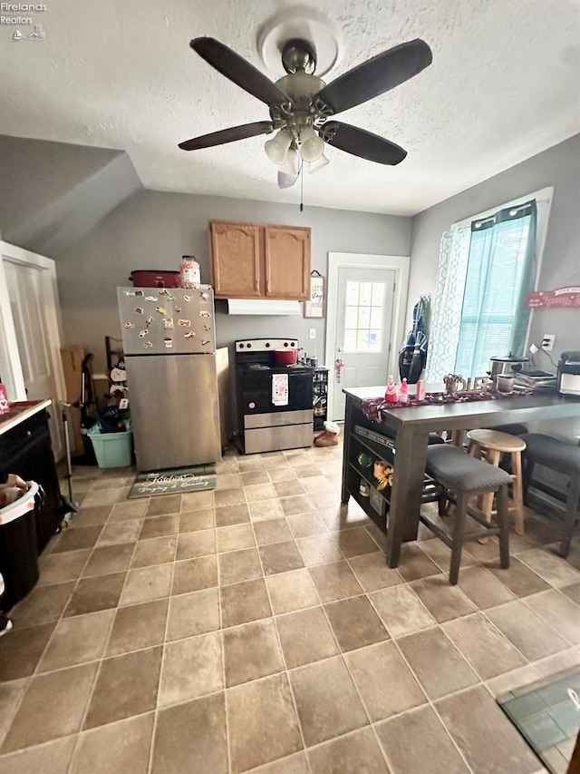 kitchen with appliances with stainless steel finishes, a textured ceiling, and ceiling fan