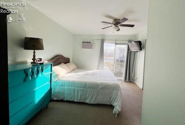 bedroom featuring carpet flooring, ceiling fan, and a wall unit AC