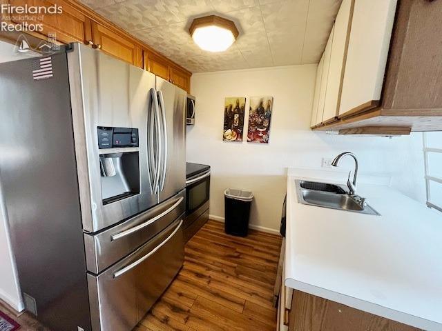 kitchen featuring sink, stainless steel appliances, and dark hardwood / wood-style floors