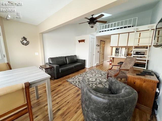 living room featuring ceiling fan and light wood-type flooring